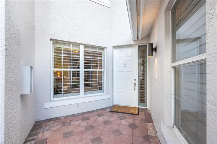 Doorway to property featuring a patio area
