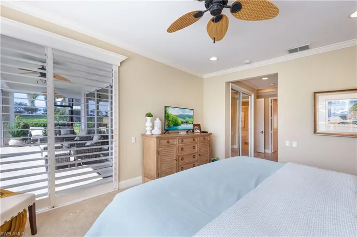 Bedroom featuring light carpet, access to outside, crown molding, and ceiling fan