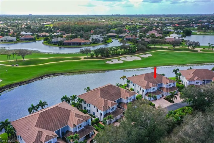 Birds eye view of property with a water view