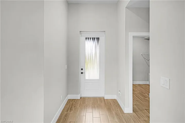 Laundry area featuring electric dryer hookup, wood tiled floors, and washer hookup