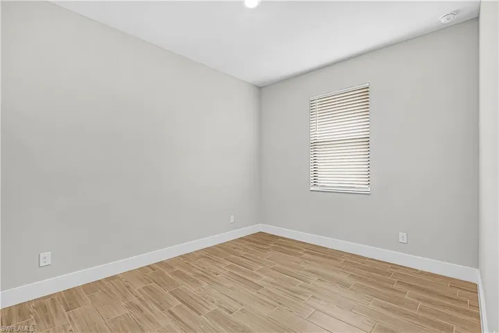 Spare room featuring wood tiled floors and a ceiling fan