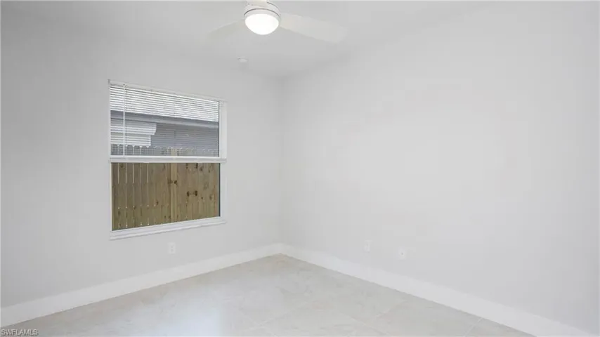 Empty room with baseboards and ceiling fan