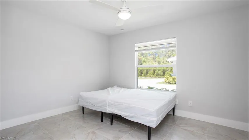 Bedroom with baseboards and a ceiling fan