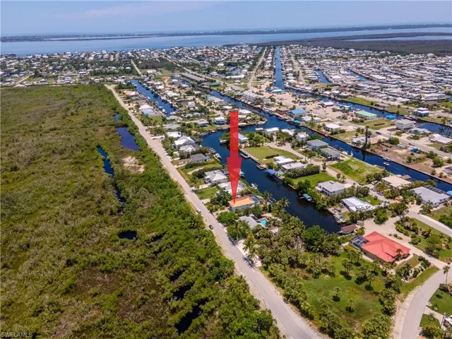 Aerial perspective of suburban area featuring a nearby body of water
