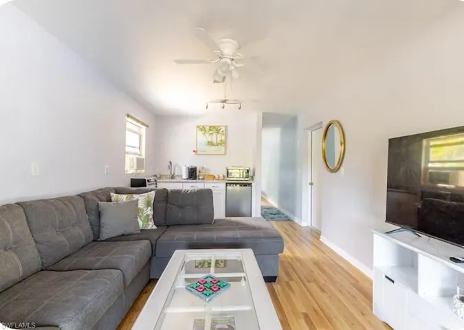 Living area with light wood-type flooring and ceiling fan