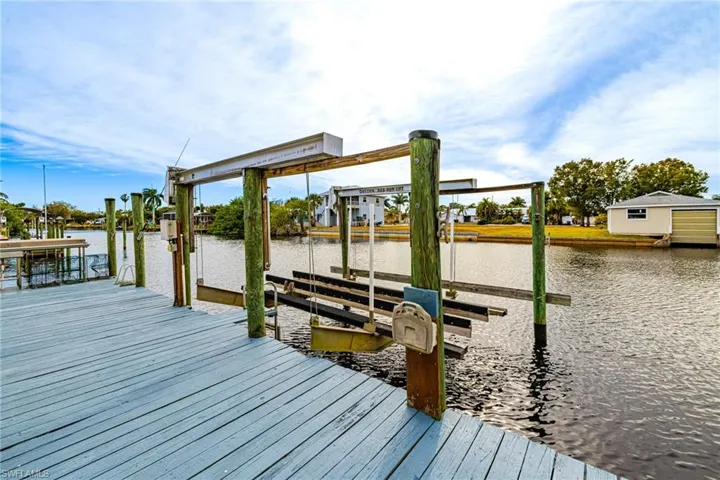 Dock area with boat lift and a water view