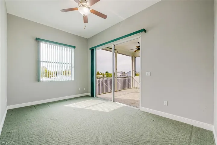 Spare room with a ceiling fan and light carpet