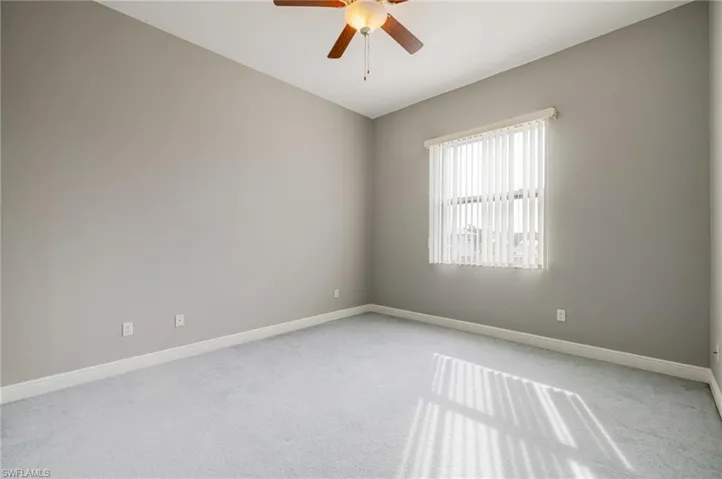 Spare room with light colored carpet and ceiling fan