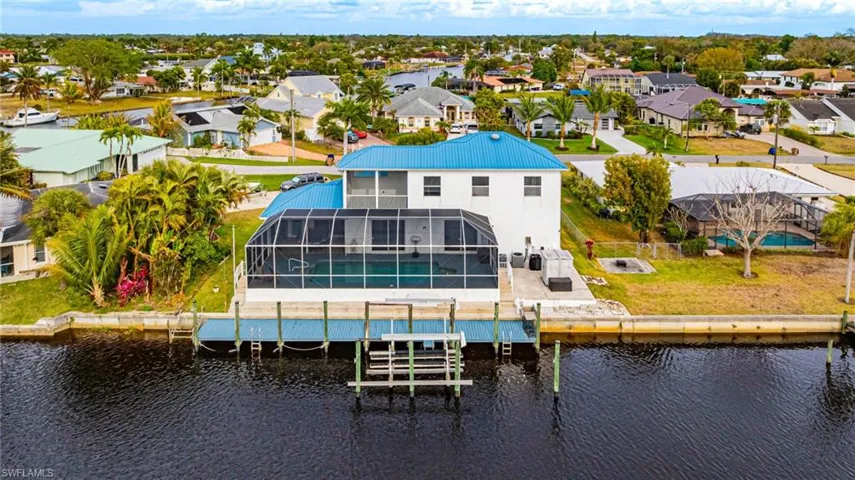 Aerial perspective of suburban area featuring a nearby body of water