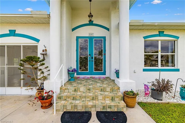 Doorway to property featuring french doors and stucco siding