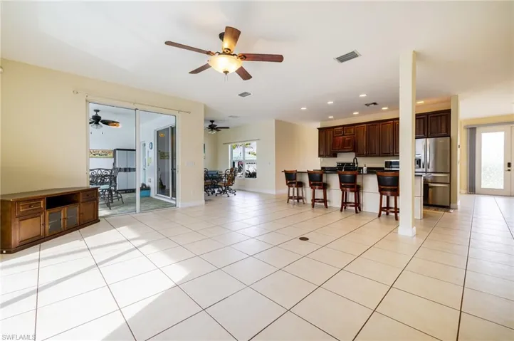 Living room featuring recessed lighting, light tile patterned floors, and french doors