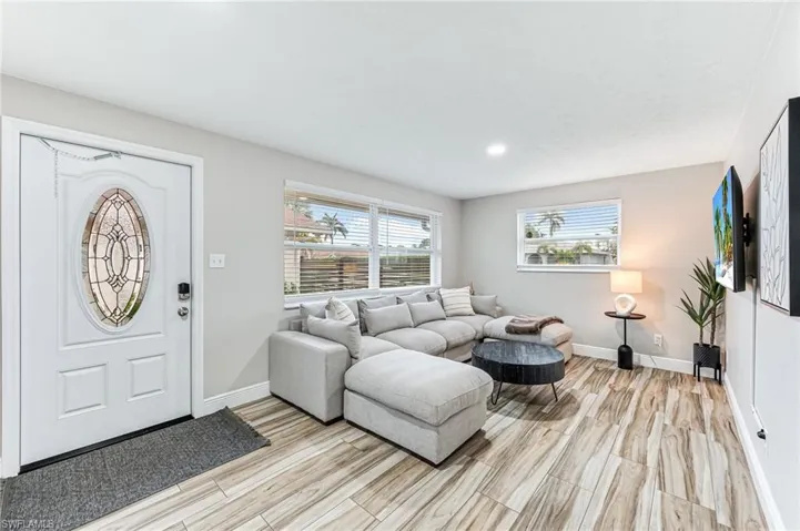 Living room with light wood tile floors throughout