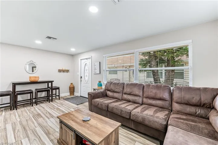 Living room with light wood-type flooring and a wealth of natural light