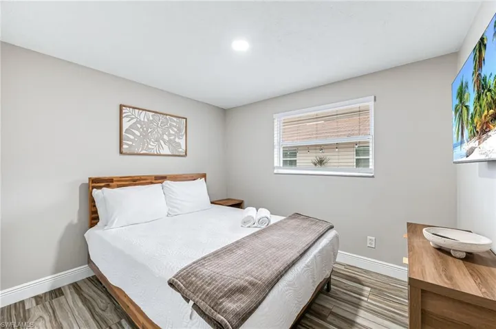 Bedroom with hardwood / wood-style floors