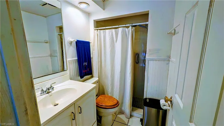 Bathroom featuring oversized vanity, toilet, and tile floors