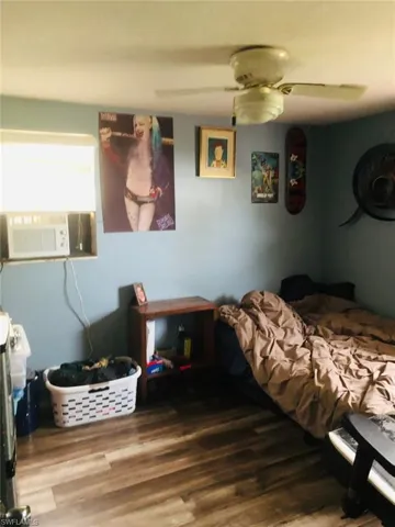 Bedroom with wood-type flooring and ceiling fan