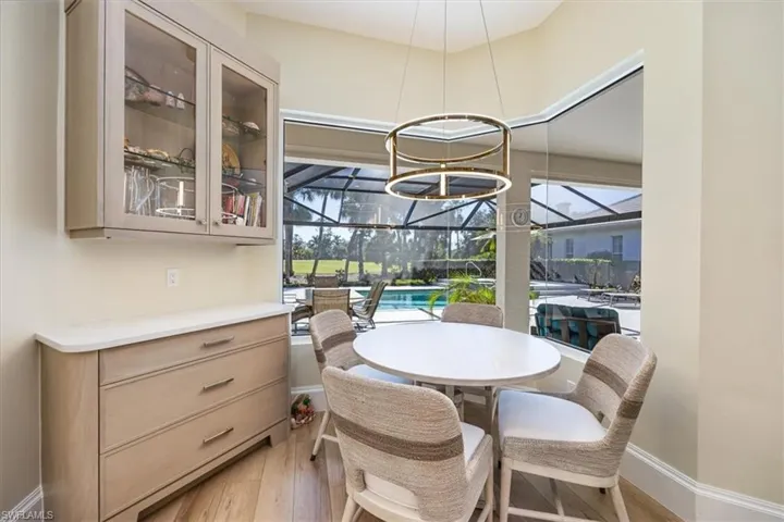 Dining area featuring light hardwood / wood-style flooring and a notable chandelier
