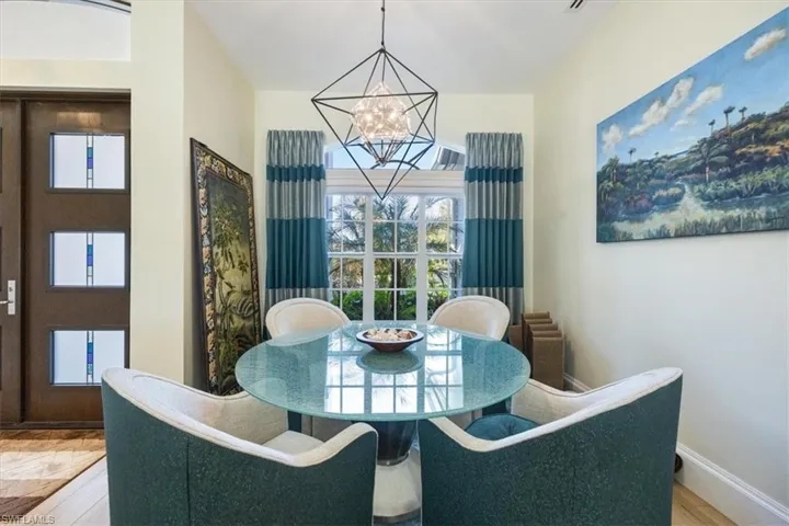 Dining space featuring radiator, a wealth of natural light, a chandelier, and hardwood / wood-style flooring