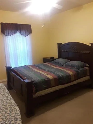 Carpeted bedroom with ceiling fan