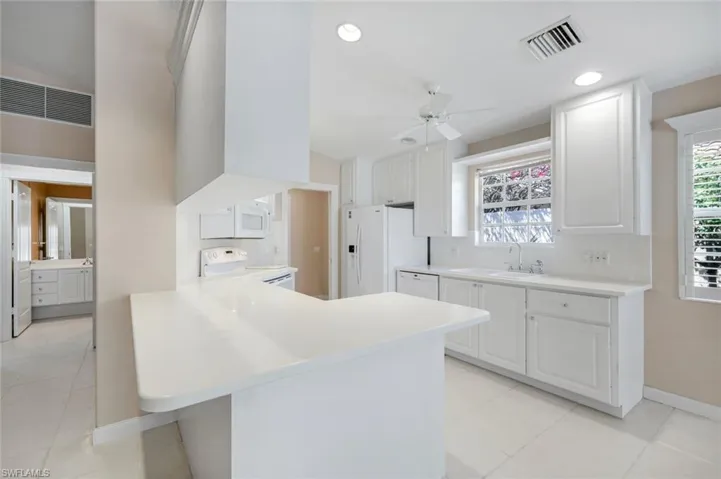 Kitchen opens to den area.