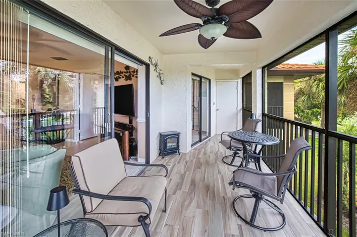 Sunroom / solarium featuring a wood stove and plenty of natural light