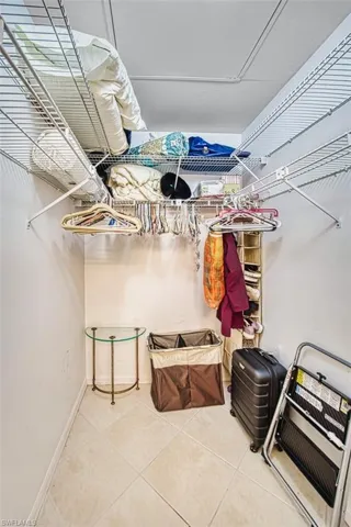 Spacious closet with light tile patterned flooring
