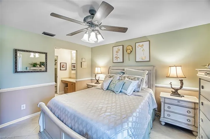 Bedroom with light tile patterned floors and ceiling fan