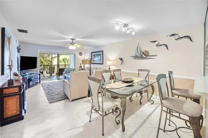 Dining space featuring light tile patterned floors and a ceiling fan
