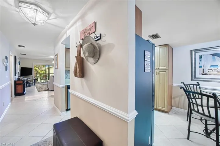 Hallway with light tile patterned flooring