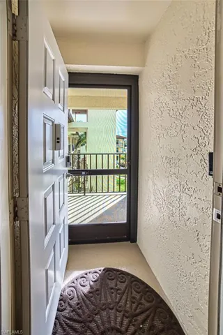 Doorway featuring a textured wall