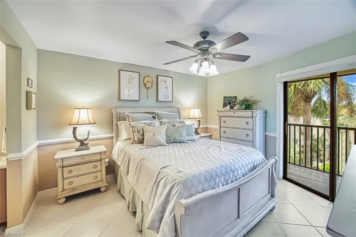 Bedroom featuring access to exterior, light tile patterned floors, and a ceiling fan
