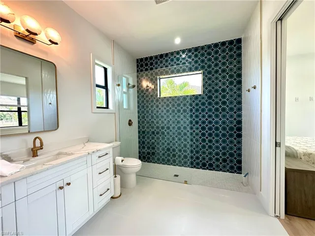 Ensuite bathroom featuring walk in shower and vanity