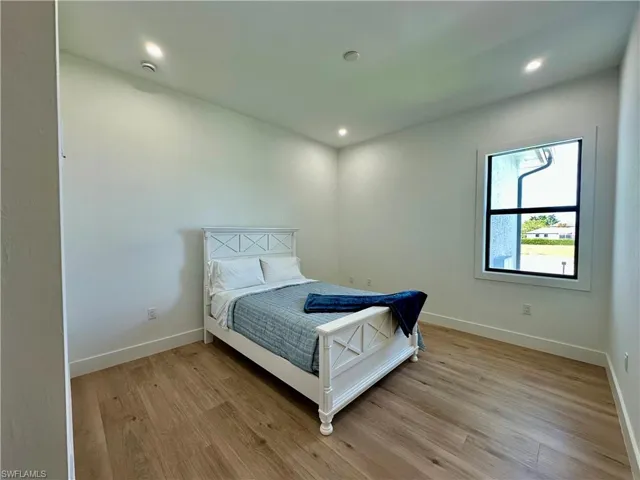Bedroom with light wood-style flooring and recessed lighting