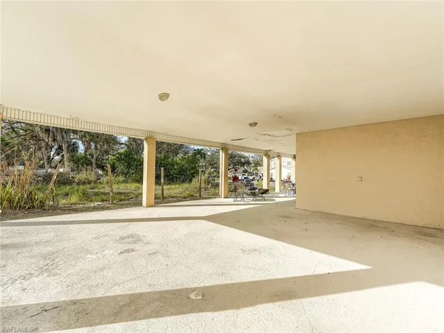 Back of house featuring a patio area, a lawn, and a balcony