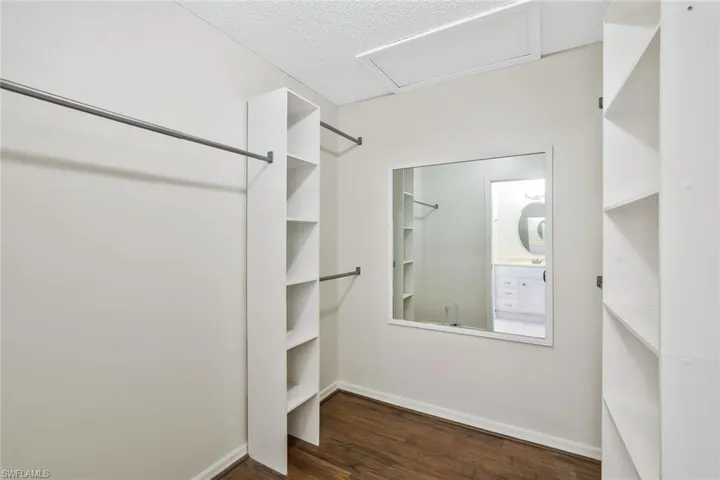 Walk in closet featuring wood finished floors