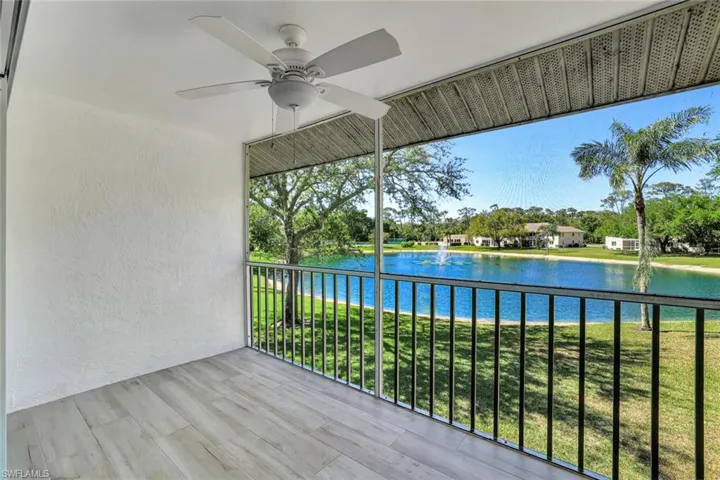 Balcony featuring a water view and a ceiling fan