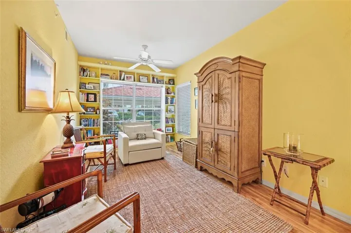 Living area with wood-type flooring and ceiling fan