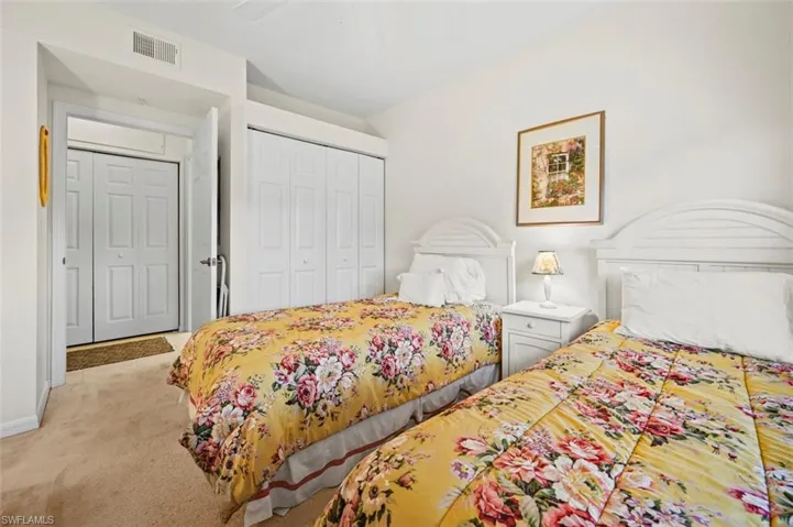 Bedroom featuring ceiling fan, a closet, and light carpet