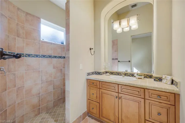 Bathroom with a tile shower and vanity