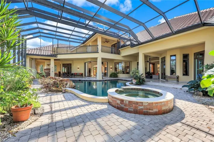 View of swimming pool featuring a lanai, an in ground hot tub, ceiling fan, and a patio