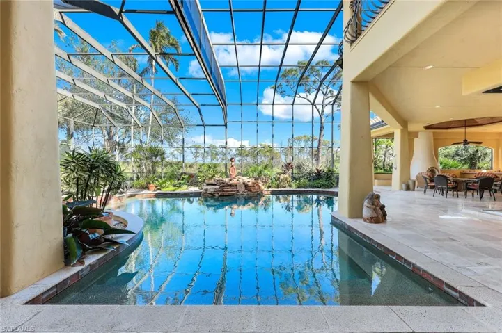 View of pool featuring a patio, ceiling fan, and a lanai