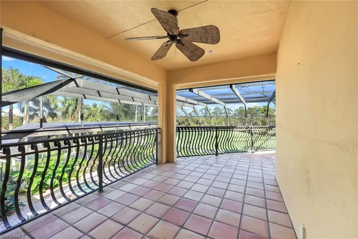 View of patio featuring glass enclosure and ceiling fan