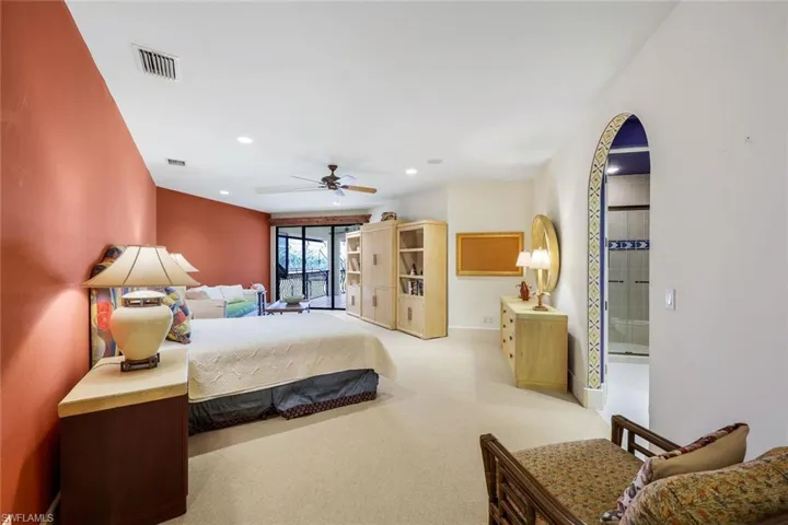 Carpeted bedroom featuring ceiling fan