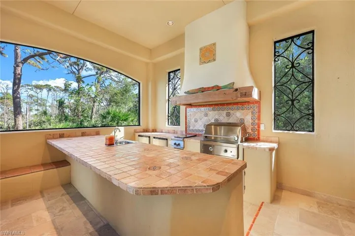 View of patio / terrace with an outdoor kitchen, a grill, and sink