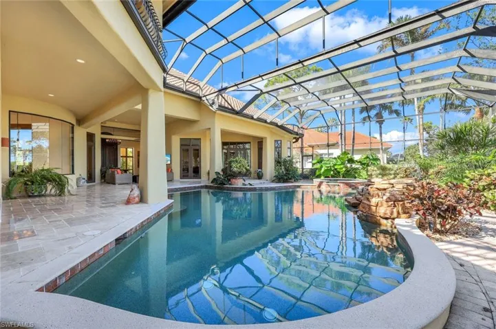 View of pool featuring a lanai, ceiling fan, and a patio