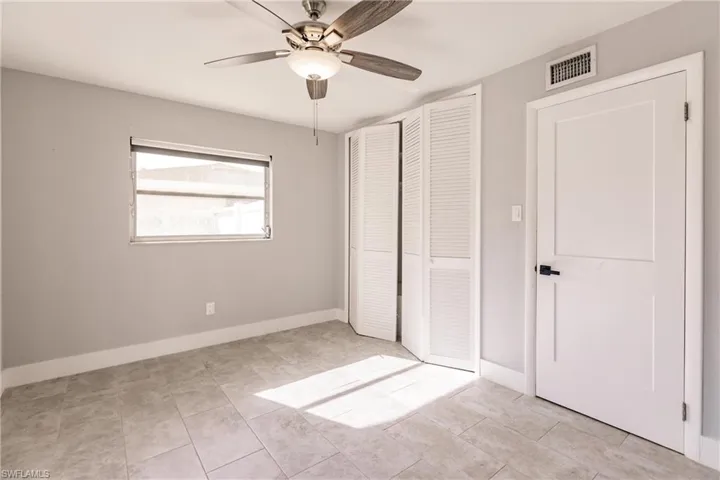 Unfurnished bedroom featuring a ceiling fan and a closet