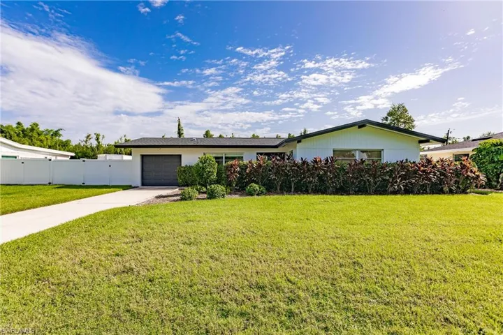 Ranch-style home featuring an attached garage and driveway