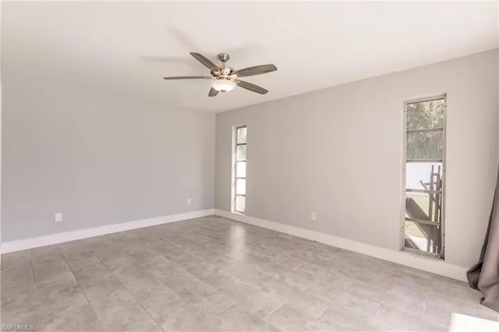 Spare room featuring baseboards and a ceiling fan
