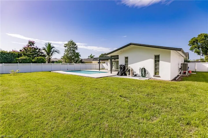 Back of property with a fenced backyard, stucco siding, and a patio