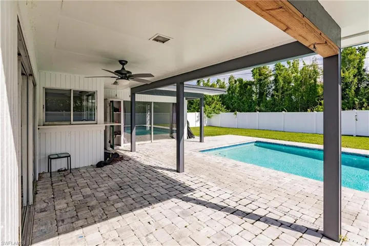 View of swimming pool with a patio area and a fenced backyard